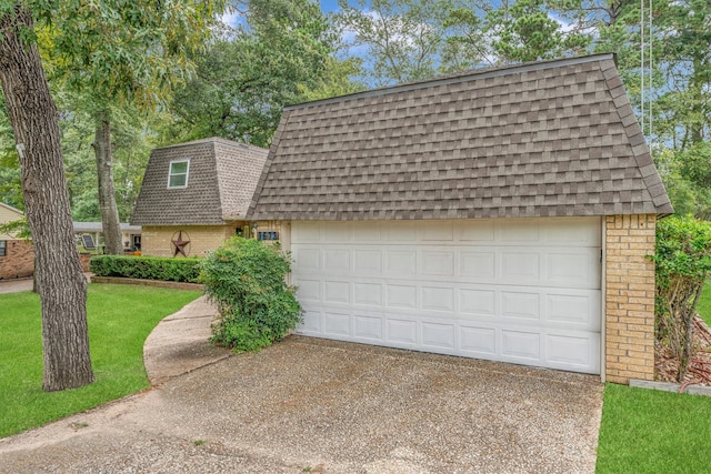 garage featuring a lawn