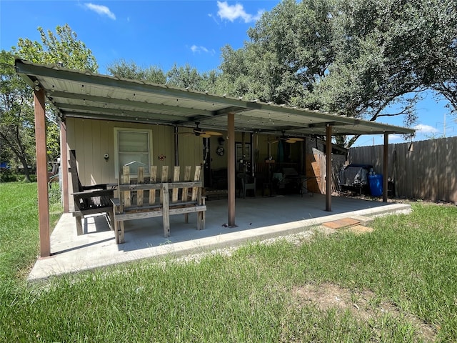 back of house featuring ceiling fan, a yard, and a patio