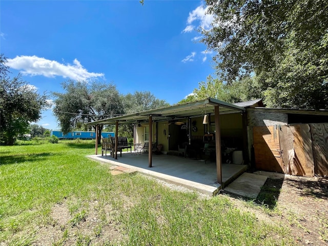 8860 S State Highway 71, El Campo, TX 77437 - exterior space with a lawn, a ceiling fan, and a patio area