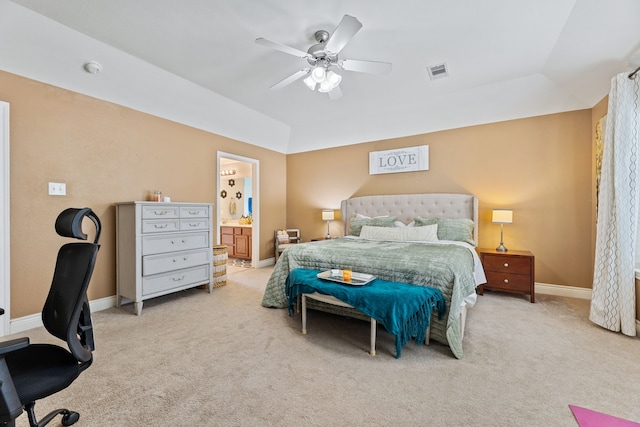 carpeted bedroom featuring vaulted ceiling, ensuite bathroom, and ceiling fan