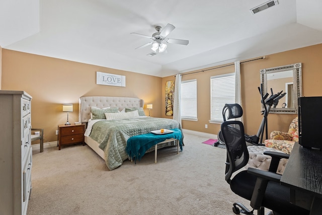 bedroom with lofted ceiling, ceiling fan, and light carpet