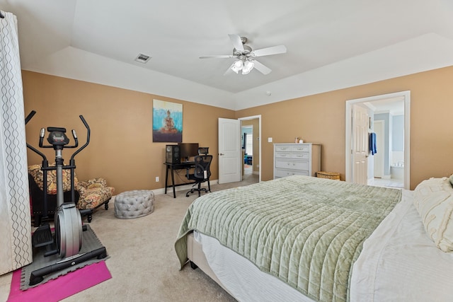 bedroom with light carpet, ensuite bathroom, and ceiling fan