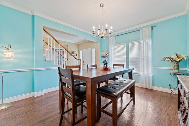 dining area with crown molding, dark hardwood / wood-style floors, and a chandelier