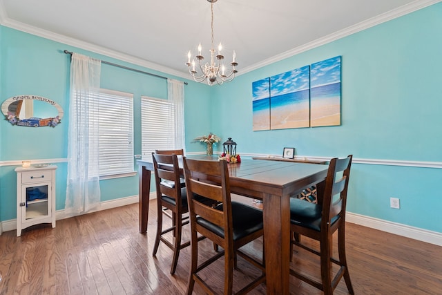 dining area featuring ornamental molding, dark hardwood / wood-style flooring, and an inviting chandelier