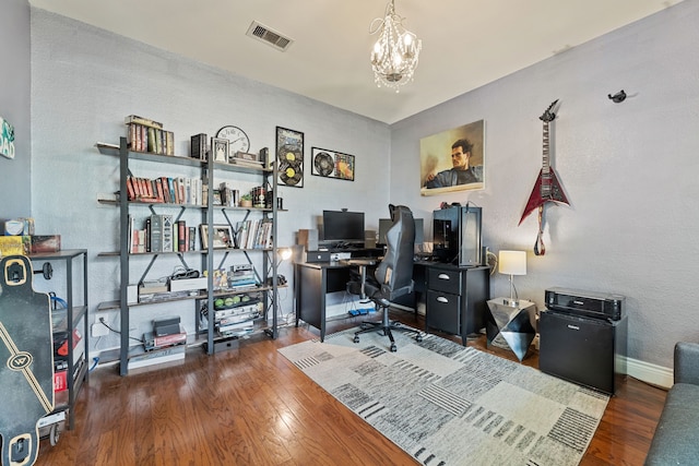 office space featuring a chandelier and dark hardwood / wood-style floors