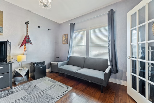 living room with a chandelier and dark hardwood / wood-style flooring