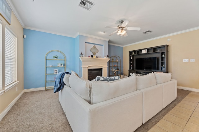 living room with crown molding, ceiling fan, and tile patterned flooring