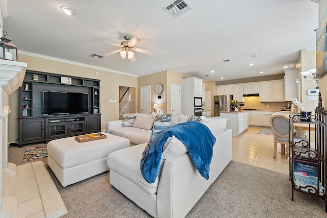 tiled living room with ornamental molding, sink, and ceiling fan