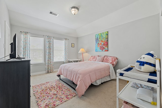 carpeted bedroom with vaulted ceiling