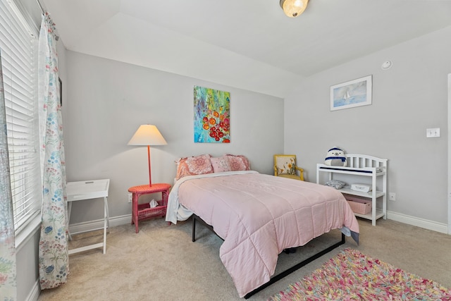 carpeted bedroom featuring vaulted ceiling and multiple windows