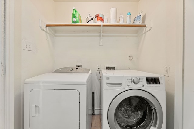 washroom with washer and dryer and tile patterned flooring