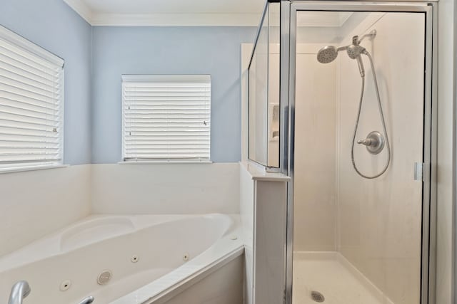 bathroom featuring crown molding and separate shower and tub