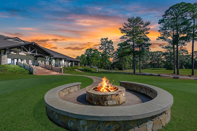 view of property's community featuring a fire pit and a lawn