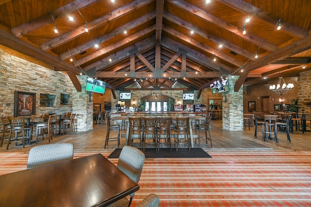 interior space featuring wooden ceiling, an inviting chandelier, high vaulted ceiling, and beam ceiling