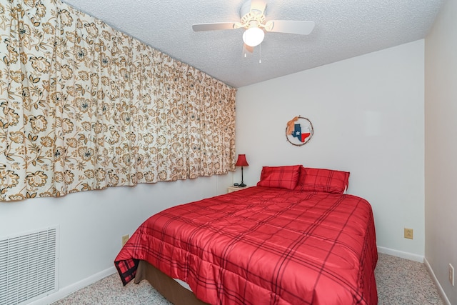 carpeted bedroom with a textured ceiling and ceiling fan