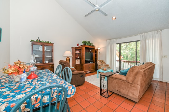 dining space featuring a textured ceiling, high vaulted ceiling, ceiling fan, and tile patterned flooring