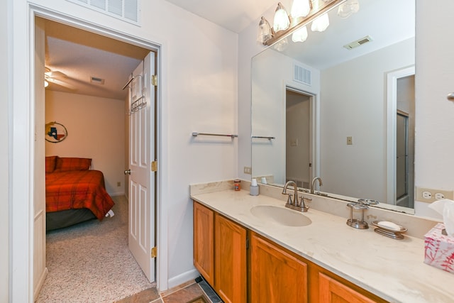 bathroom featuring vanity, ceiling fan, and a shower