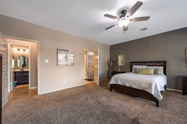 bedroom featuring a textured ceiling, connected bathroom, ceiling fan, and carpet flooring