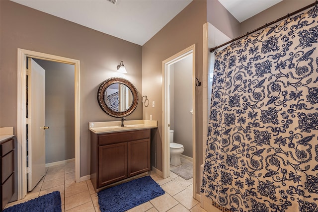 bathroom with a shower with shower curtain, tile patterned flooring, toilet, and vanity