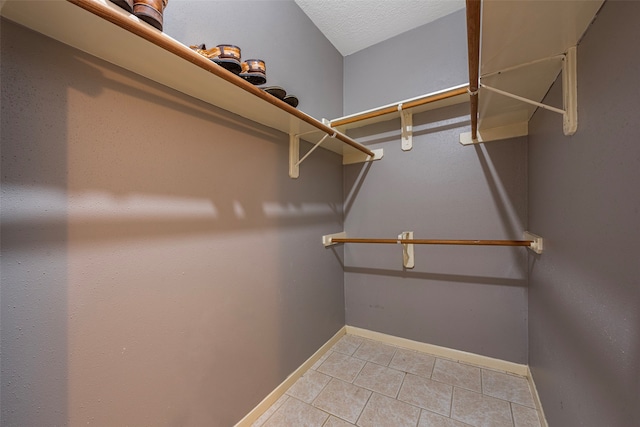 spacious closet with tile patterned flooring