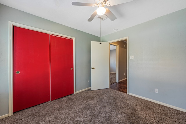 unfurnished bedroom featuring dark colored carpet, ceiling fan, and a closet