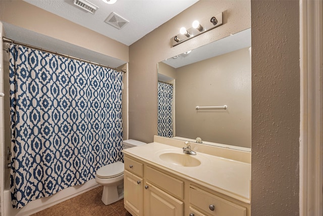 full bathroom with a textured ceiling, vanity, shower / bath combination with curtain, toilet, and tile patterned floors