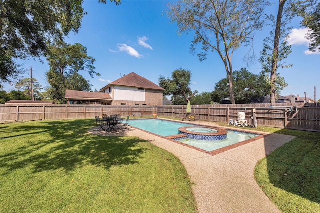 view of swimming pool featuring a lawn and an in ground hot tub