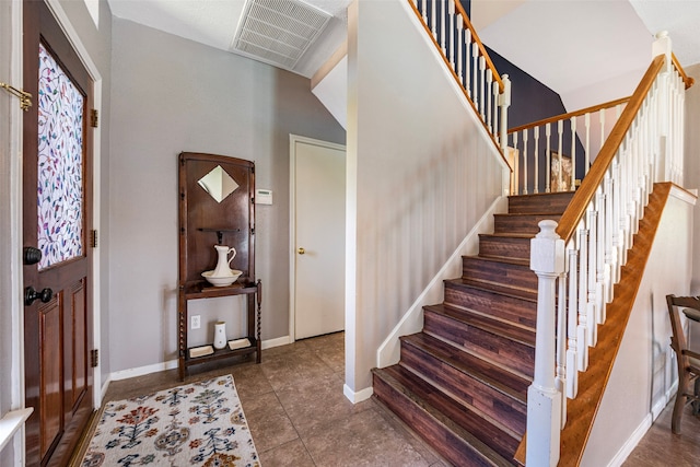 tiled foyer with a high ceiling