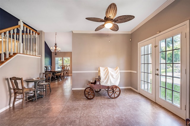 sitting room featuring ceiling fan with notable chandelier, french doors, crown molding, and plenty of natural light