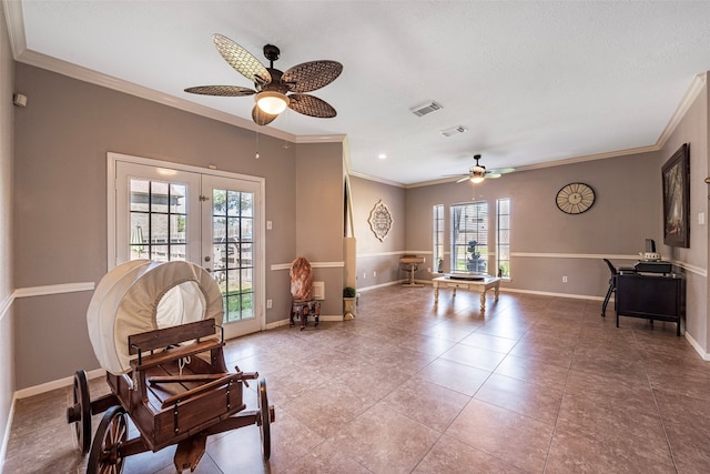 sitting room with french doors, ceiling fan, and a healthy amount of sunlight