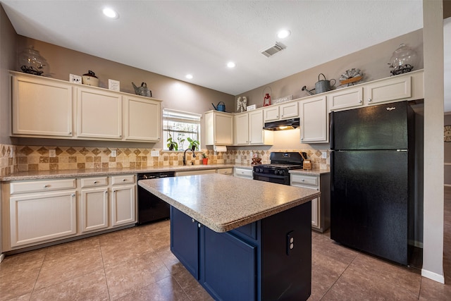 kitchen with light tile patterned floors, black appliances, a center island, and tasteful backsplash