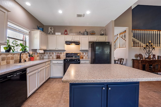 kitchen featuring black appliances, sink, a center island, and white cabinetry