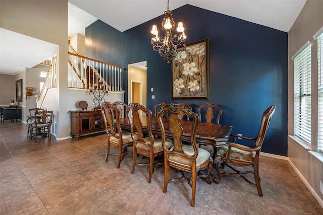 dining area with a notable chandelier and high vaulted ceiling