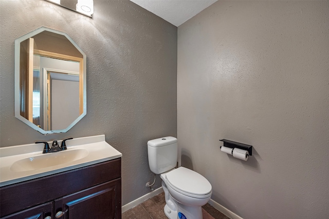 bathroom featuring vanity, toilet, and tile patterned floors