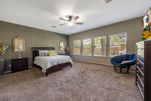 carpeted bedroom with a textured ceiling and ceiling fan