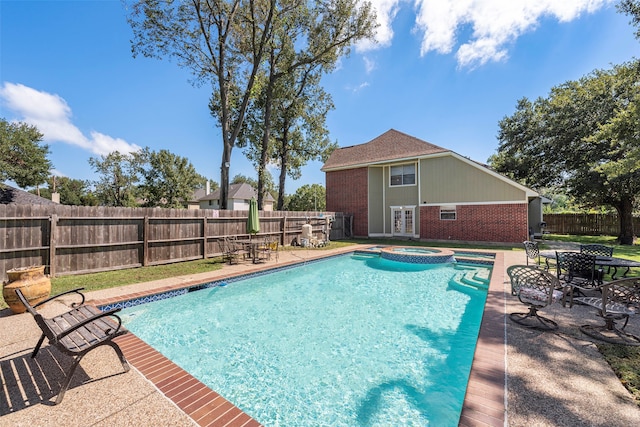 view of pool with an in ground hot tub and a patio