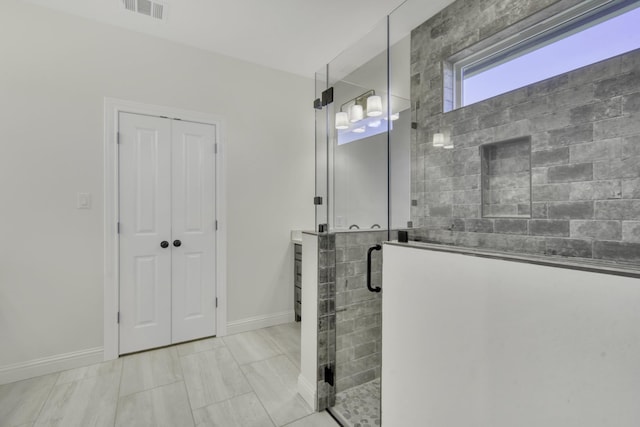 bathroom with a shower with shower door