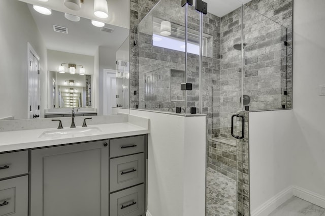 bathroom with vanity and a shower with shower door