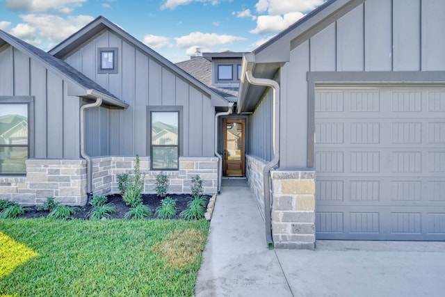 property entrance with a yard and a garage