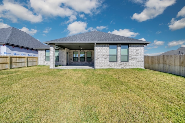 rear view of house with a lawn, ceiling fan, and a patio