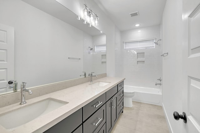 full bathroom featuring vanity, tiled shower / bath combo, toilet, and tile patterned floors