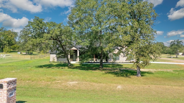 view of home's community featuring a yard