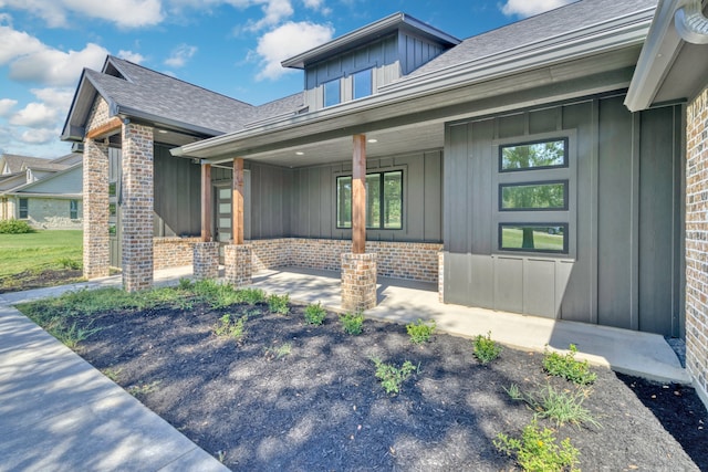 view of exterior entry with a porch