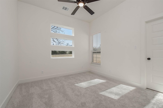 empty room featuring ceiling fan and light carpet