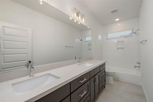 full bathroom featuring tiled shower / bath combo, vanity, tile patterned floors, and toilet