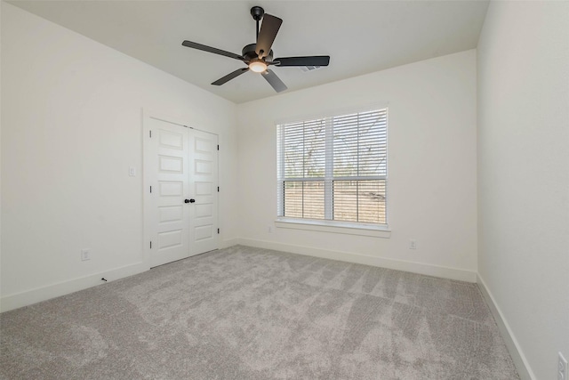 empty room featuring light carpet and ceiling fan