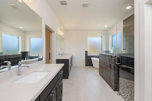 bathroom with independent shower and bath, vanity, and backsplash