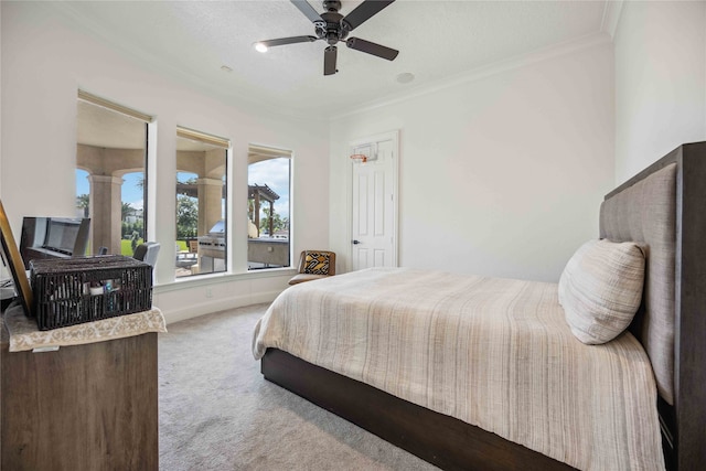 carpeted bedroom with ceiling fan, a textured ceiling, and ornamental molding