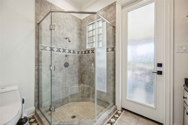 bathroom with a shower with door, vanity, and toilet