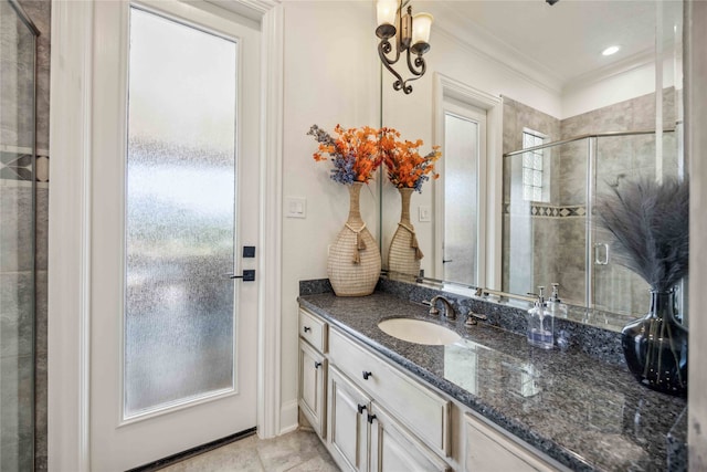 bathroom featuring crown molding, vanity, an enclosed shower, and tile patterned flooring